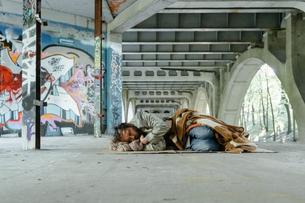 a man sleeping on a cardboard