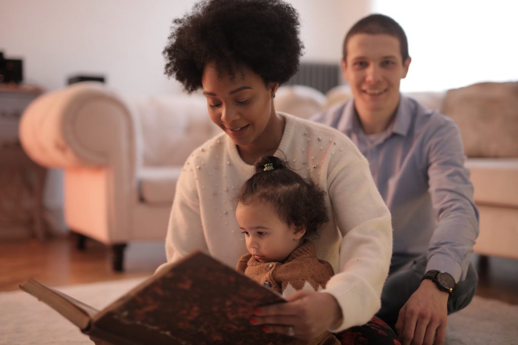 photo of woman reading a story to her child