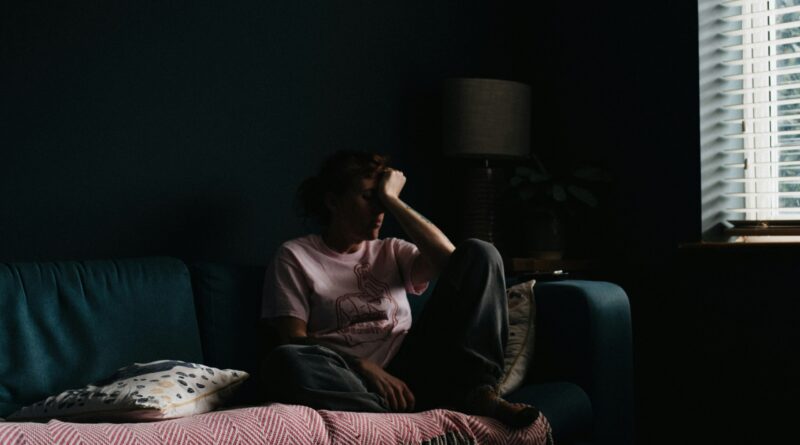 woman in purple dress sitting on couch