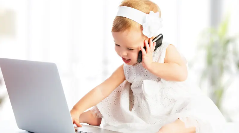 Baby on laptop and mobile phone