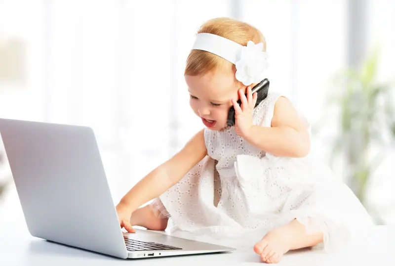 Baby on laptop and mobile phone