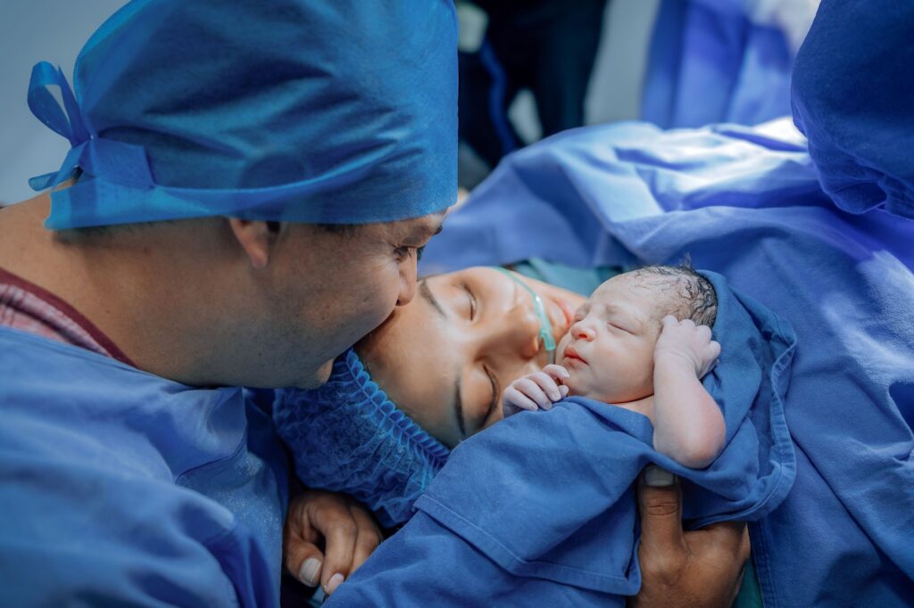 newborn baby with parents in hospital setting