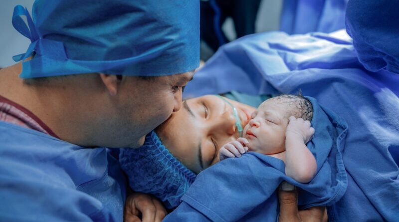 newborn baby with parents in hospital setting