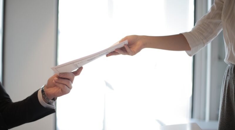 job applicant passing her documents